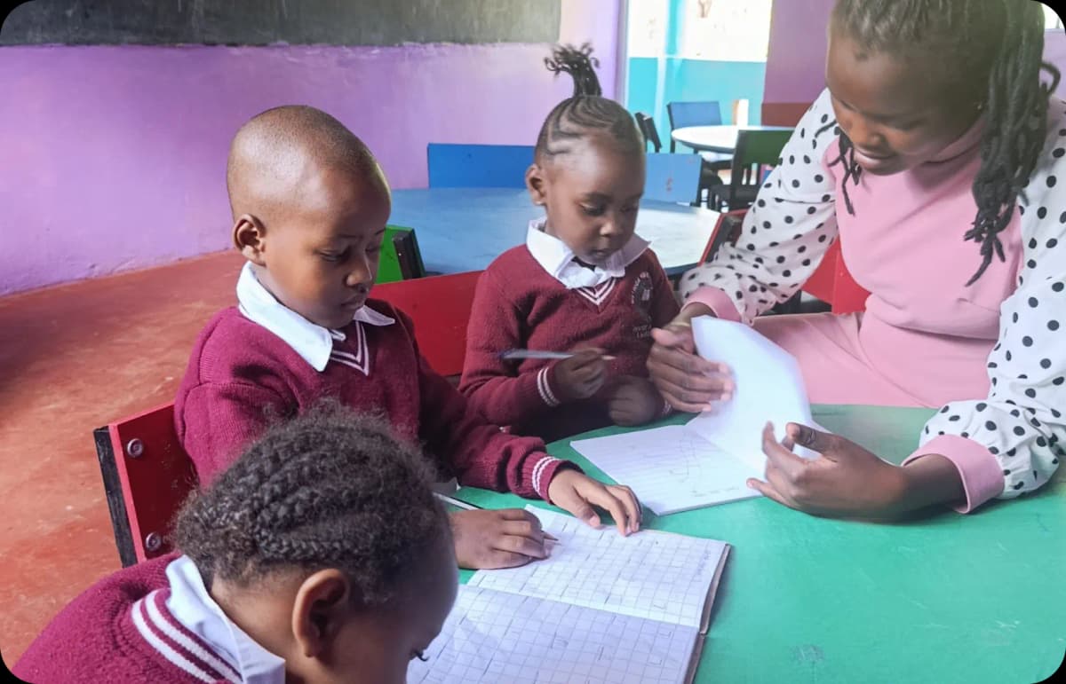 A female teacher in classroom assisting a student